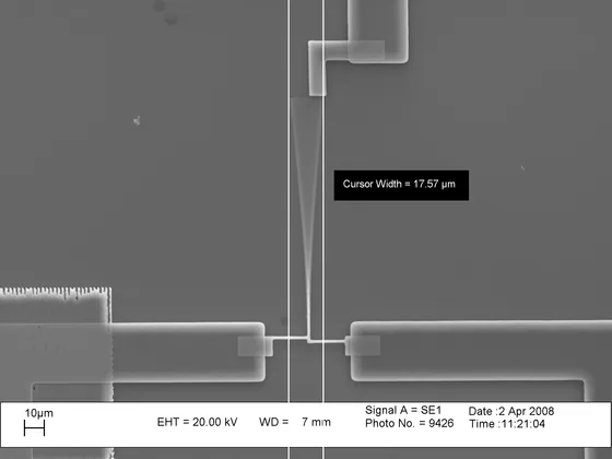 Scanning electron micrograph of a MEMS cantilever microstructure with its SEM info bar — an illustrative example of a released micro-electro-mechanical device